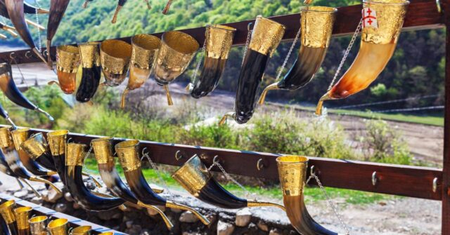 Different types and sizes of drinking horns hanging and displayed.