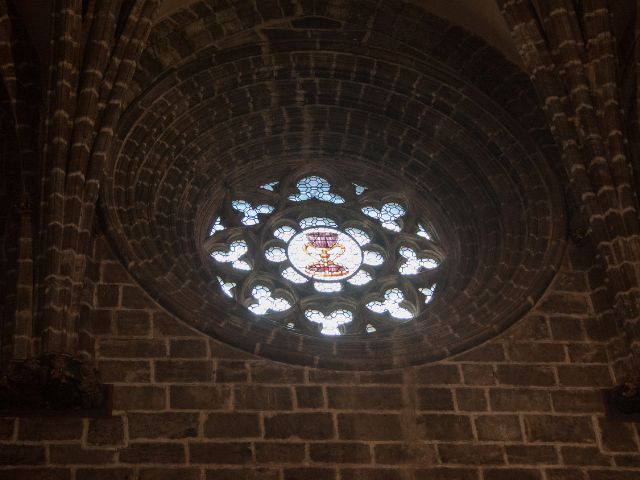 Stained window with a holy grail in a cathedral.