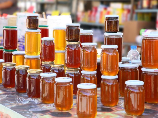 Differenct colors of honey in various jars.