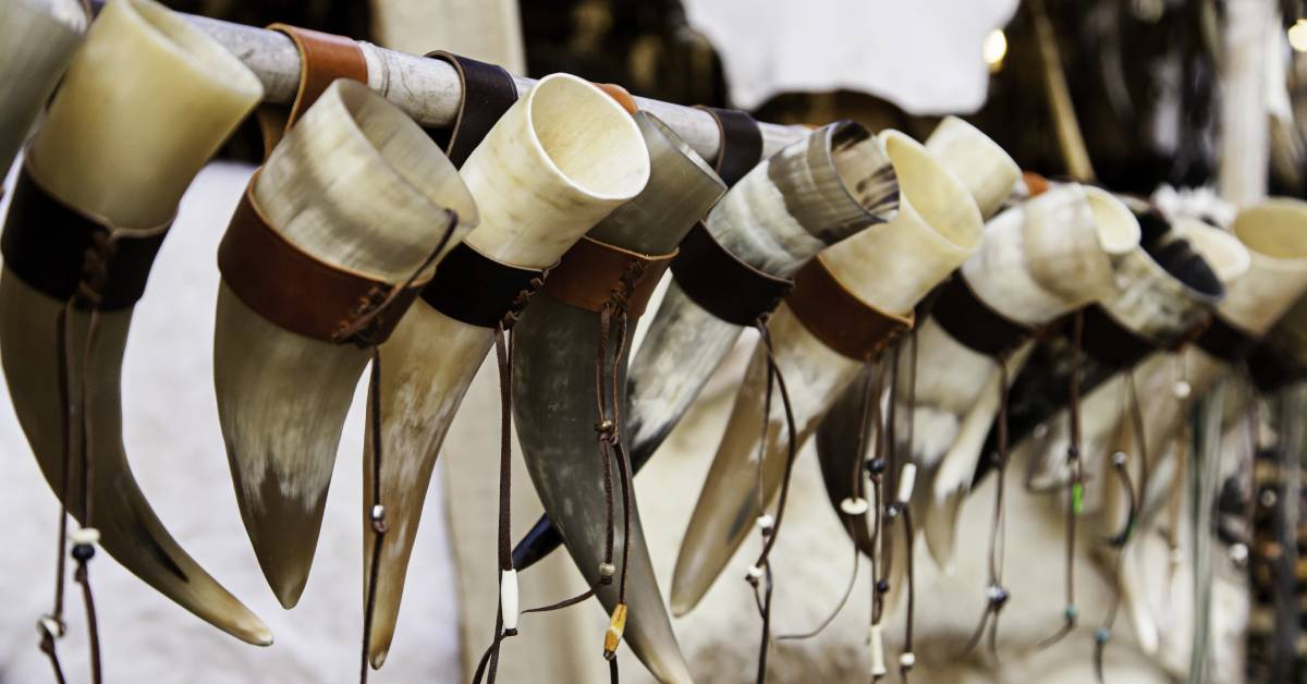 Raw-looking drinking horn hanging and lined-up properly.