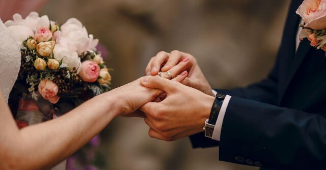 Couple exchanging rings on a wedding ceremony.